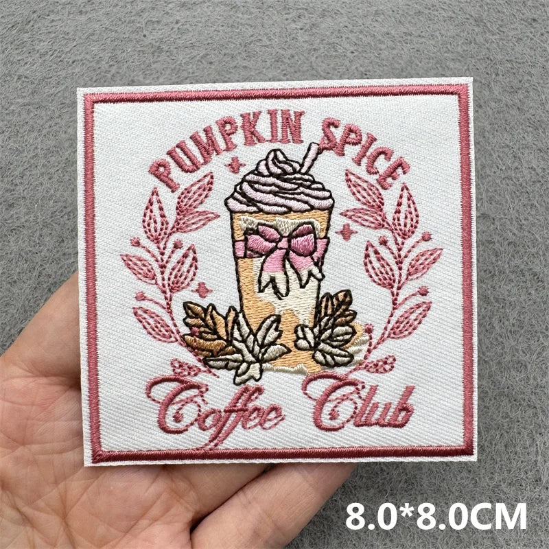 Pink embroidered patch featuring a pumpkin spice theme with coffee club text and floral elements
