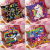 A collection of double-sided printed square pillow covers featuring colorful cats and rainbows on pink fabric.