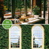 A window with decorative ironwork and a wooden sill showing various glass products.