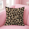 A square decorative pillow cover featuring a brown and black leopard print on a pink sofa.