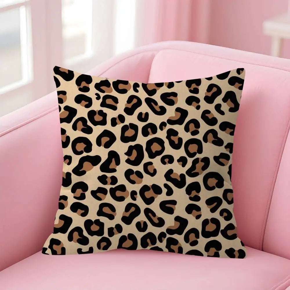 A square decorative pillow cover featuring a brown and black leopard print on a pink sofa.