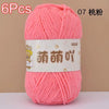 A skein of bright pink soft bulky chenille yarn labeled in Chinese characters and packaged for crafting