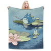 A soft fleece throw blanket featuring the Totoro character in a watercolor style on a teal background.