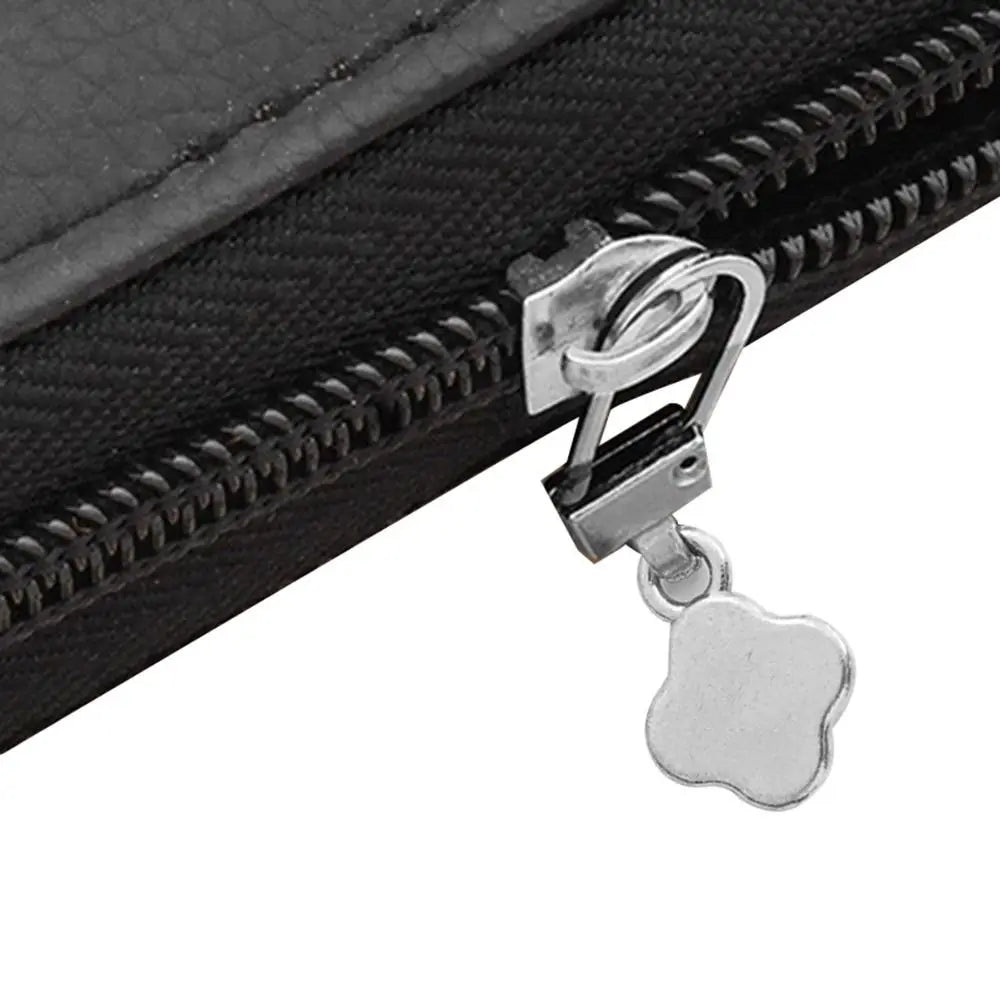 A close-up of a silver metal zipper pull replacement kit attached to a black fabric zipper.