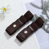 A dark brown stretch elastic belt is shown next to a white flower and green foliage.