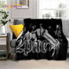 A dark graphic print featuring a stylized face and a vintage firearm design on a throw blanket.