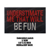 Black embroidered patch with red text that reads UNDERESTIMATE ME THAT WILL BE FUN
