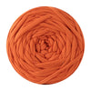 A ball of orange-colored soft T-shirt yarn used for crochet