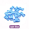A pile of light blue adjustable plastic paracord buckle bracelets.