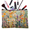 Floral canvas cosmetic bag with zipper closure featuring a vibrant mix of yellow, pink, and green flowers.