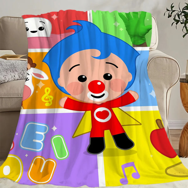 A colorful plush character design on a blanket featuring a blue-haired figure with a red nose and red shirt.