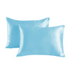 A pair of light blue satin pillowcases lying flat.