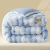 A light blue ultra-warm plush rabbit quilt comforter folded and displayed on a neutral surface.