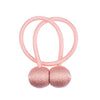 Pink magnetic curtain tiebacks with looped cords and spherical ends