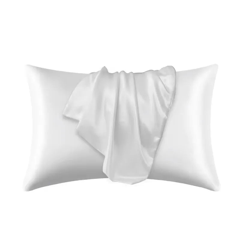 A white silky satin pillowcase is shown folded, ready for use on hair or skin.
