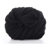 A ball of black hand-woven chunky chenille yarn.