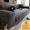 A gray jacquard plush elastic sofa cover with a black accent pillow and non-slip backing.