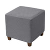 Gray woven jacquard stretch ottoman slipcover with wooden legs