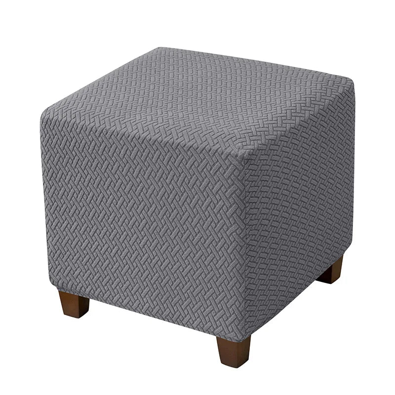 Gray woven jacquard stretch ottoman slipcover with wooden legs
