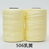 Spool of light yellow hand knitting and crochet cord for crafting