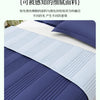 A close-up of a folded blue and white quilted blanket with subtle vertical lines.