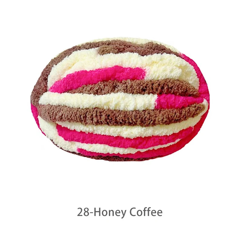 A ball of hand-knitted yarn in stripes of pink, white, and brown representing 28-Honey Coffee.