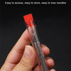 A hand holds a clear glass tube containing multiple steel sewing needles for storage and easy access.