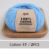 A ball of light blue 100% organic cotton yarn labeled QJH for knitting and crochet.