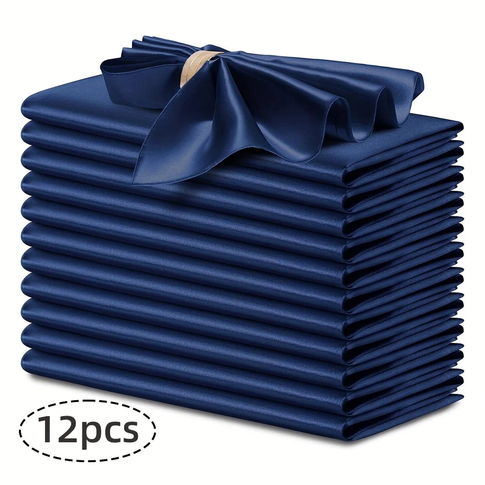 A stack of twelve navy blue silky satin dinner napkins with a decorative bow.