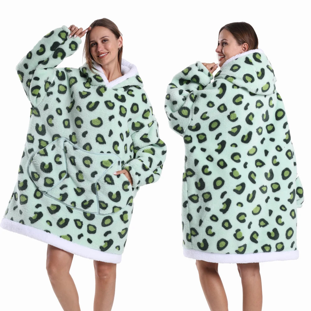 A woman models a light green leopard print oversized patchwork fleece hoodie.