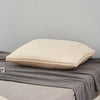 A cream-colored luxury goose down and feather bed pillow resting on a gray blanket.