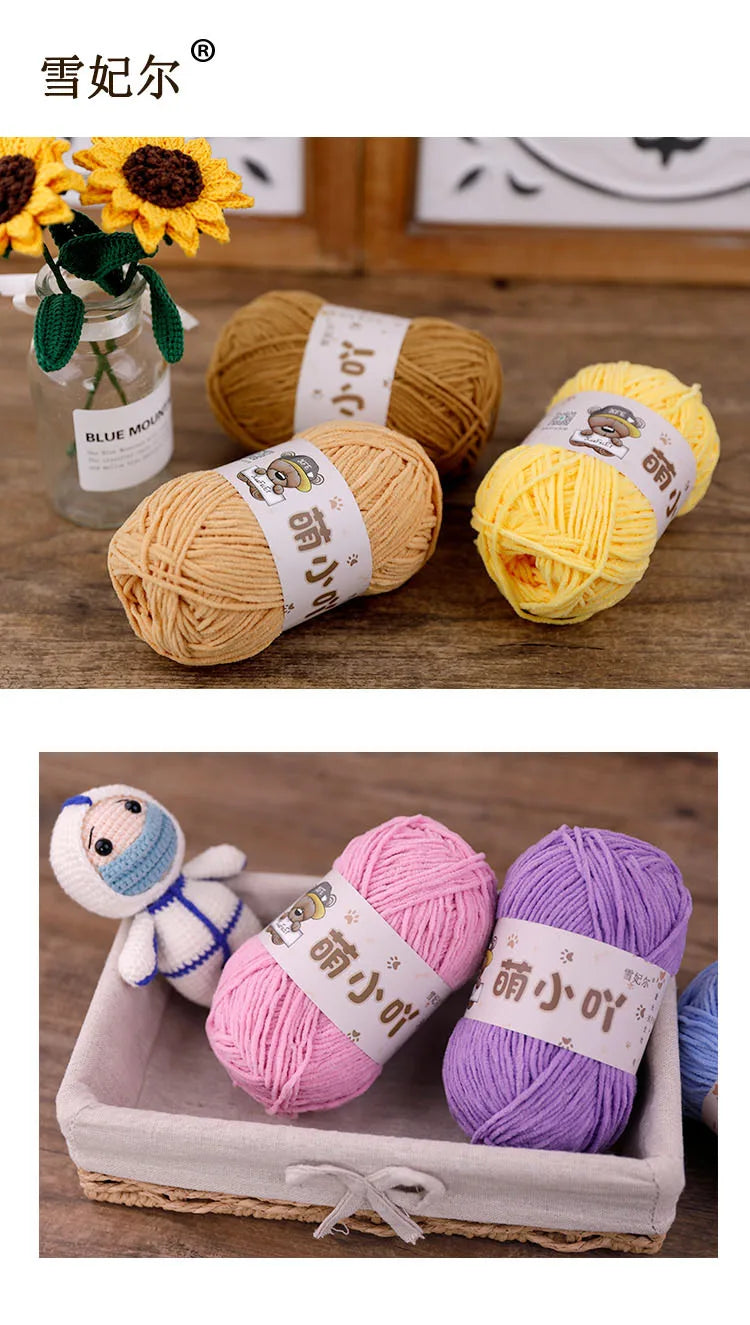 Three skeins of matte chenille yarn in pink, purple, and yellow are displayed on a wooden surface.