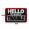 Black and red embroidered patch with white text reading HELLO MY NAME IS TROUBLE