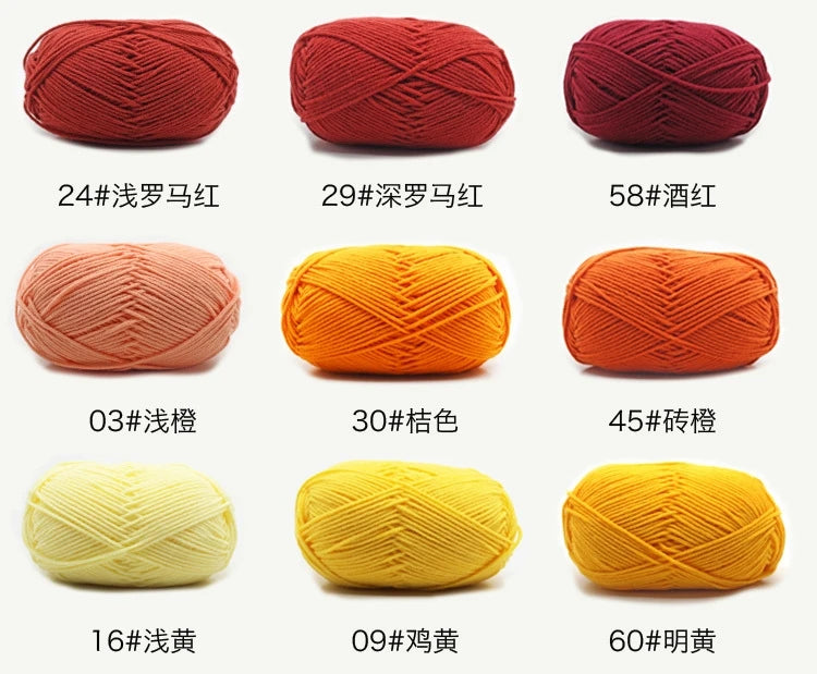 A collection of various colored and textured knitting yarns including red, orange, pink, yellow, and gold shades.