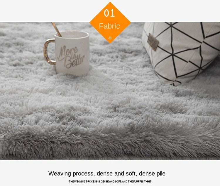 A close-up of a gray fluffy floor mat with a geometric pattern, featuring a mug and a pillow.