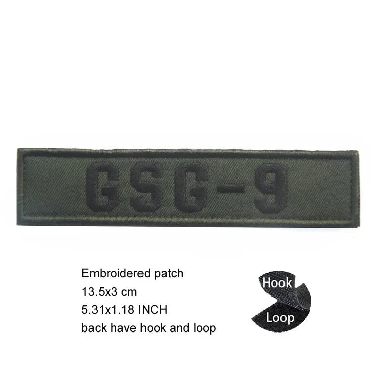 Dark olive green embroidered patch with the text GSG-9 and hook and loop backing
