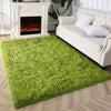 A bright lime green tie-dyed plush floor mat placed in front of a white fireplace and sofa.