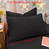 A black matte solid color pillowcase is shown on a bed with decorative star lights and a small plush toy.