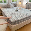 A luxury faux rabbit fur fitted sheet set displayed on a bed, with a hand touching the fabric.