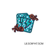 A square iron-on embroidered letter patch featuring a lightning bolt design in teal and green thread on a checkered fabric ba