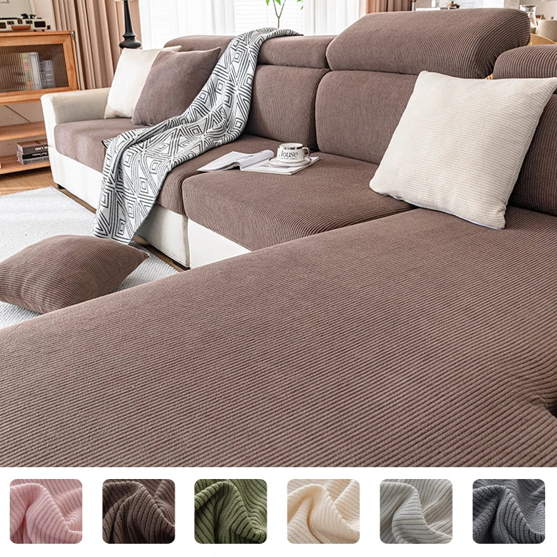 A close-up of a plush, ribbed brown sofa cushion cover with a gray patterned throw draped over it.