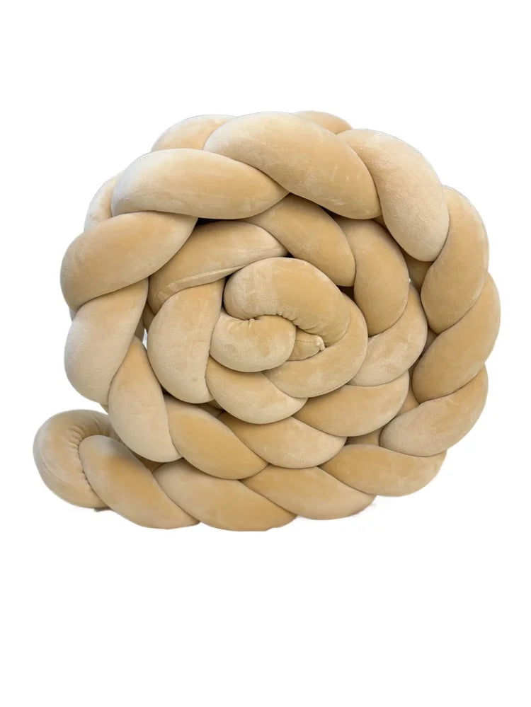 A round, light beige handmade knotted floor mat for bed decor.