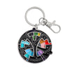 An enamel pin keychain featuring a colorful color wheel design with various colored segments.