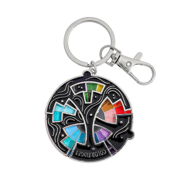 An enamel pin keychain featuring a colorful color wheel design with various colored segments.