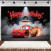 A red cartoon race car with flames is featured in a birthday party backdrop with a happy birthday sign and smoke effects.