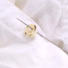 A sewing needle is shown piercing a piece of white fabric, demonstrating the precision self-threading kit.