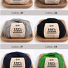 A collection of natural colored organic cotton yarn spools displayed on wooden trays.