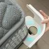 A hand is holding a white bed sheet corner tightener clip, showing the mechanism and blue indicator lines.