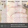 A set of three heart print duvet covers and pillow cases shown in various light settings.
