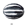 A round ball of extra thick hand-knitted yarn with horizontal black and white stripes.
